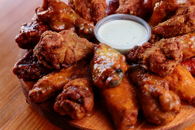 Buffalo wings with hot sauce served with celery and ranch