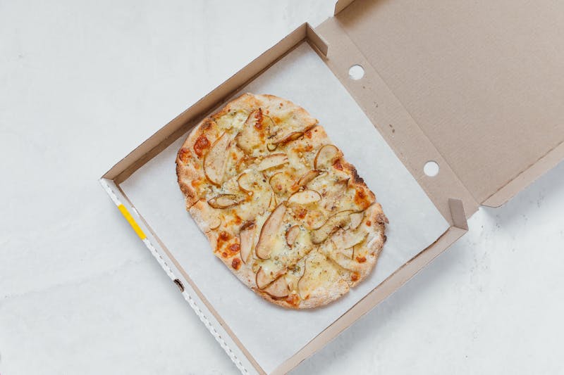 Jet's pizza kitchen — fresh pizza being prepared in Aurora